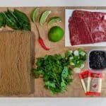 pho ingredients on a wood cutting board
